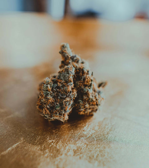 a cannabis nug sitting on top of a wood table
